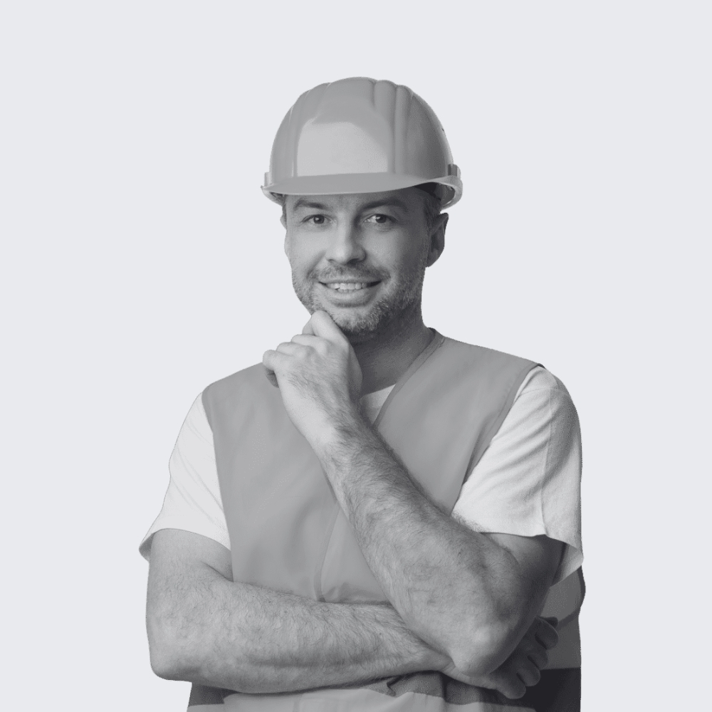 Professional handyman worker in uniform wearing tool belt and hardhat smiling at camera