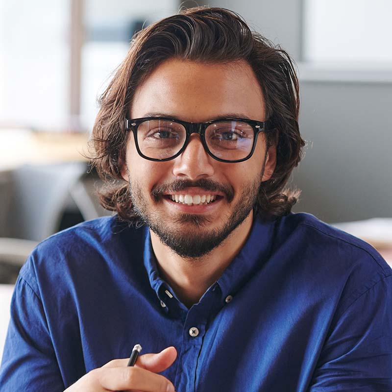 Portrait photo of man smiling at camera.